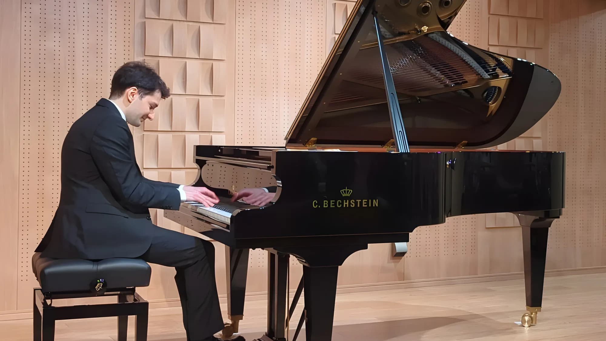 Enea playing piano in a studio