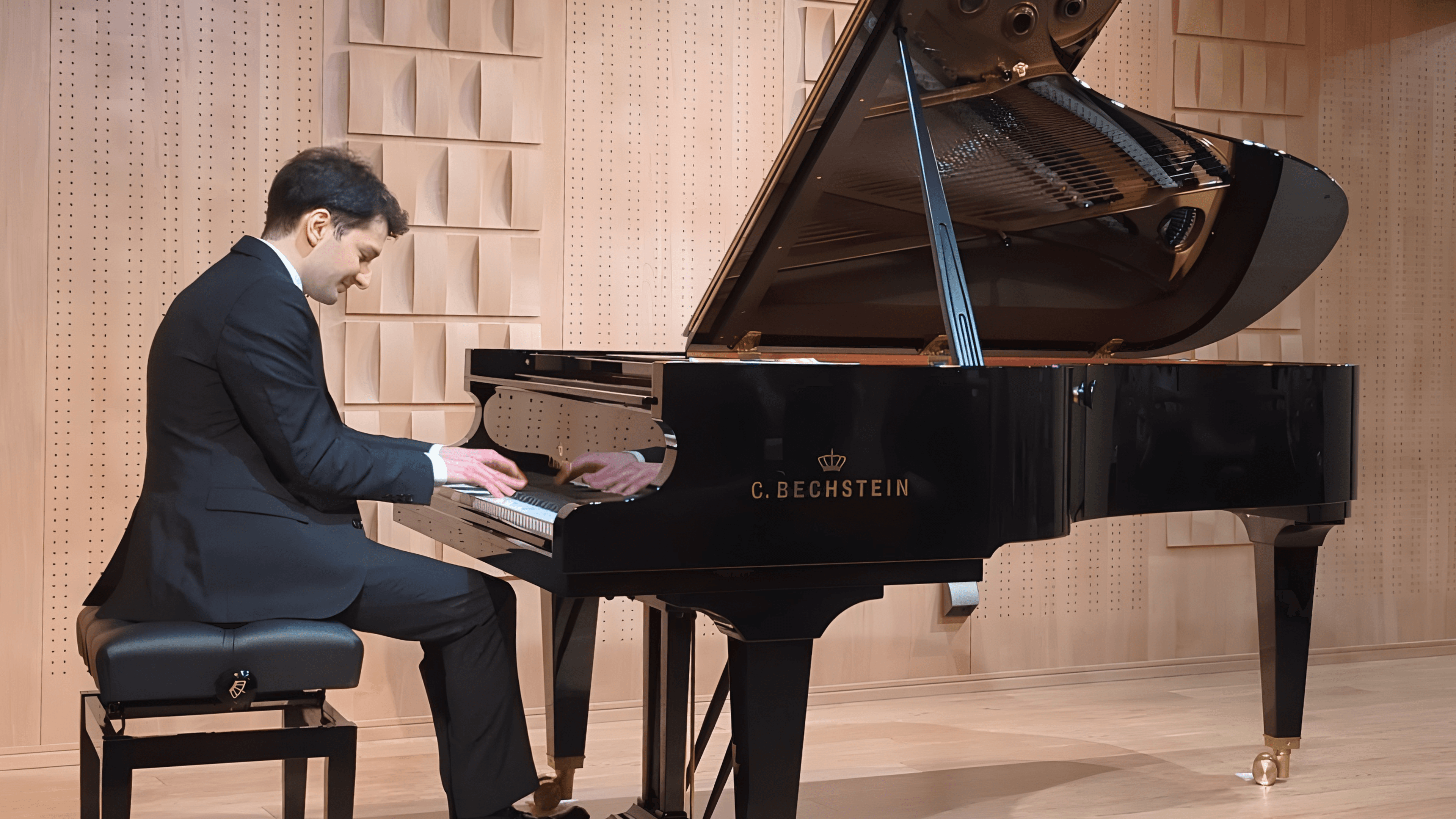 Enea playing piano in a studio