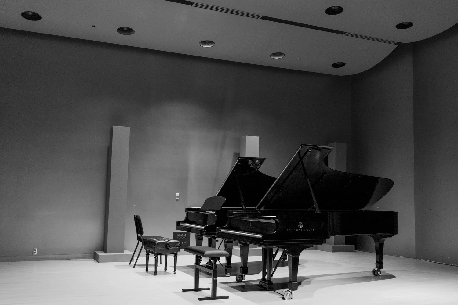 Two grand pianos on an empty concert stage in Montreal