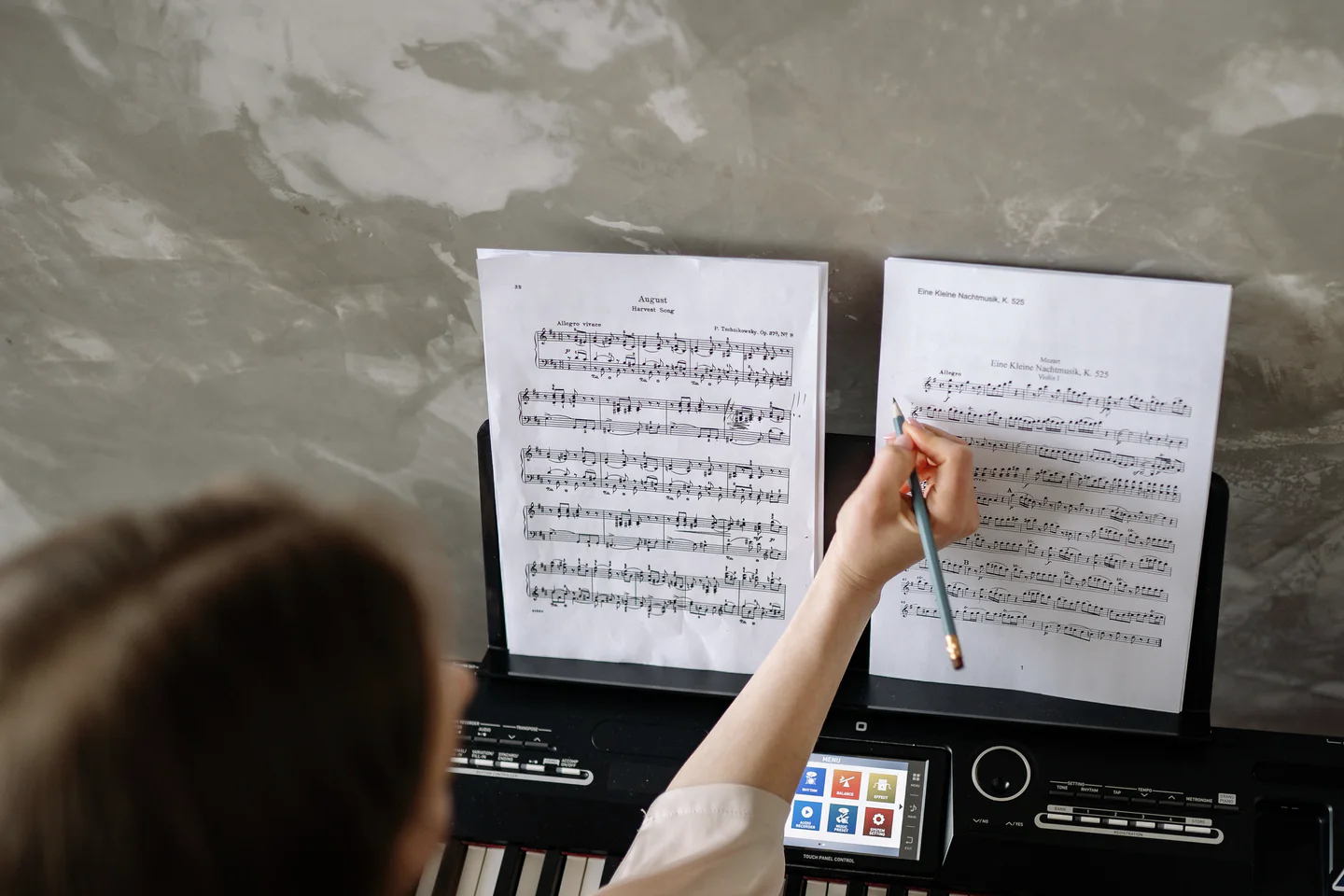 Pianist marking a difficult passage in the score with a pencil.